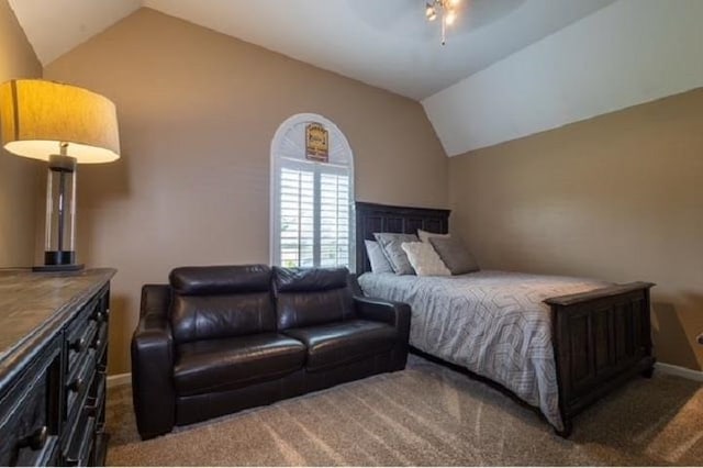 carpeted bedroom with ceiling fan and vaulted ceiling