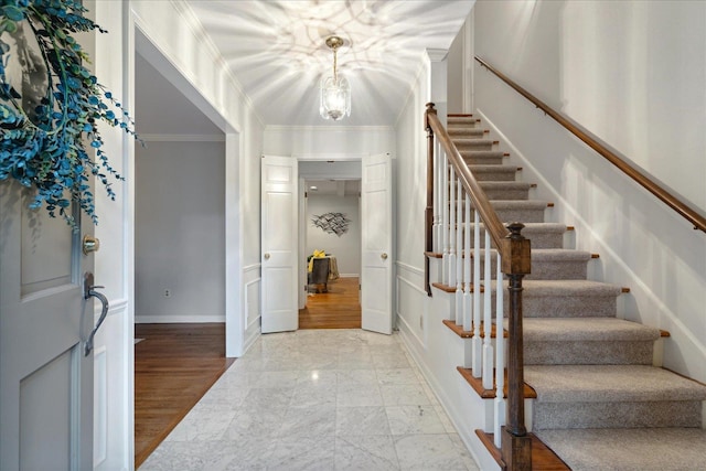 entrance foyer with light wood-type flooring and ornamental molding