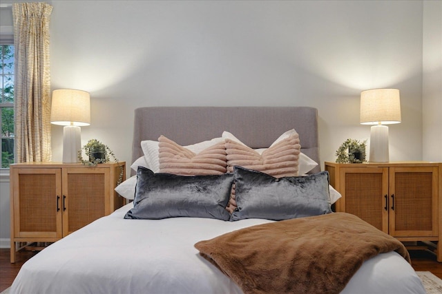 bedroom with dark wood-type flooring