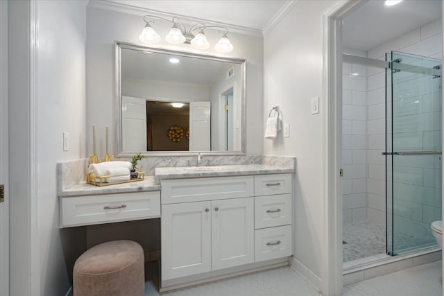 bathroom with toilet, vanity, a shower with door, and ornamental molding