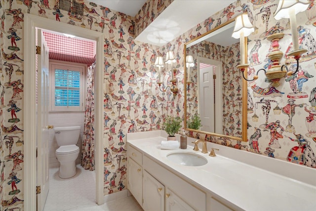 bathroom featuring toilet, vanity, and tile patterned floors