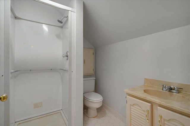 bathroom featuring tile patterned flooring, vanity, a shower, toilet, and vaulted ceiling