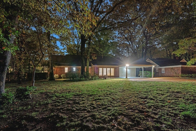 rear view of property with a yard and a patio area