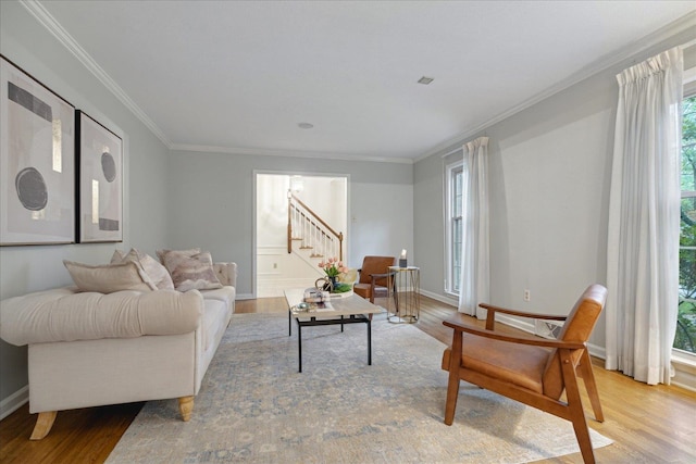 living room with light hardwood / wood-style flooring and crown molding