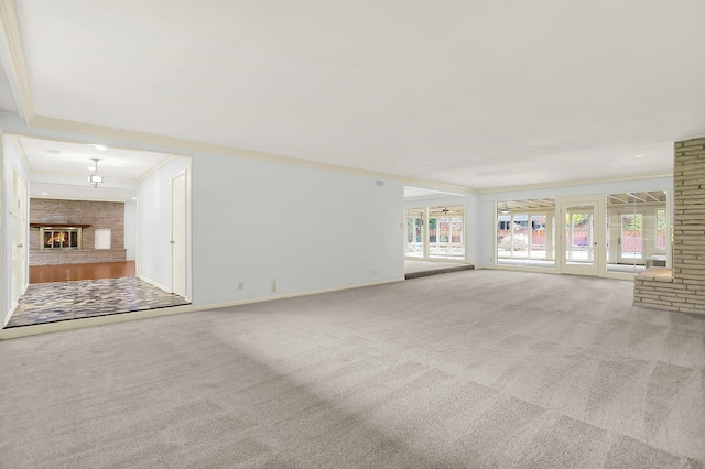 280 Waring Rd, Memphis, TN 38117 - unfurnished living room featuring carpet, ornamental molding, healthy amount of natural light, and a glass covered fireplace