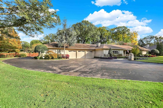 280 Waring Rd, Memphis, TN 38117 - single story home with an attached garage, asphalt driveway, and a chimney