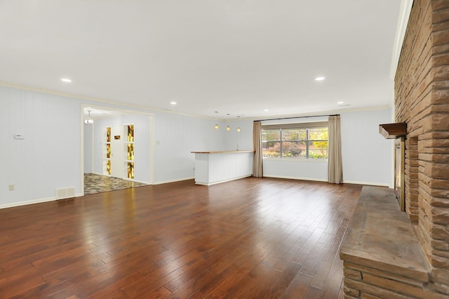 280 Waring Rd, Memphis, TN 38117 - unfurnished living room with ornamental molding, dark wood-style flooring, a stone fireplace, and recessed lighting