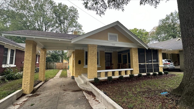 view of front of house with a carport and covered porch