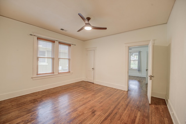 spare room featuring hardwood / wood-style floors and ceiling fan