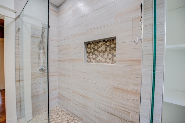 bathroom featuring a shower with shower door