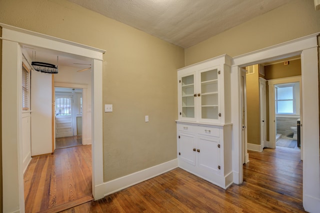 hall featuring hardwood / wood-style floors and a textured ceiling