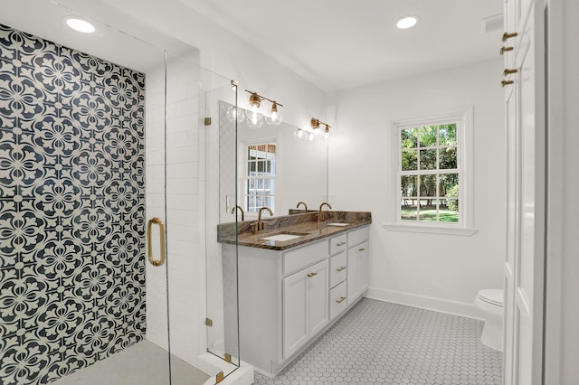 bathroom with vanity, tile patterned floors, toilet, and a shower with shower door