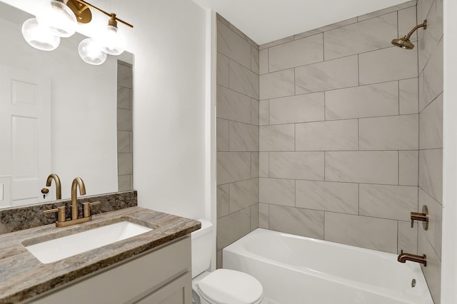 full bathroom featuring vanity, tiled shower / bath combo, and toilet