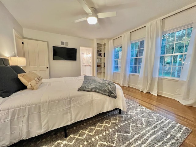 bedroom with ceiling fan and wood-type flooring