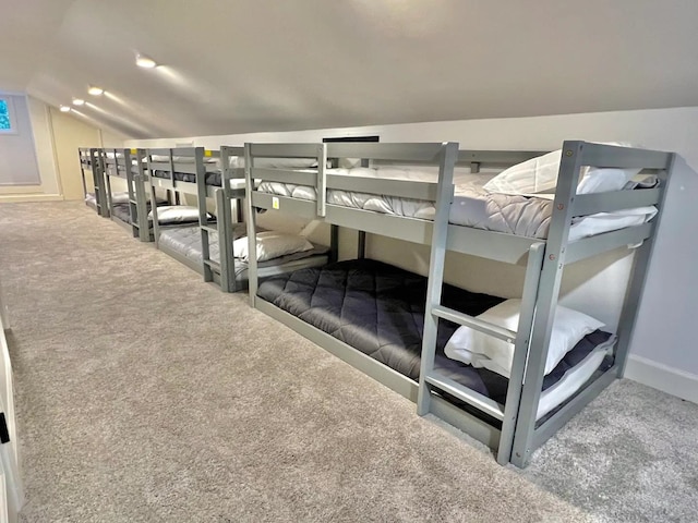 bedroom with lofted ceiling and carpet