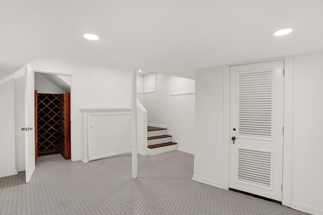 basement featuring light colored carpet