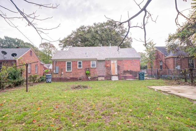 rear view of house featuring a yard