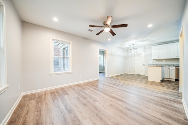 unfurnished living room with ceiling fan and light wood-type flooring