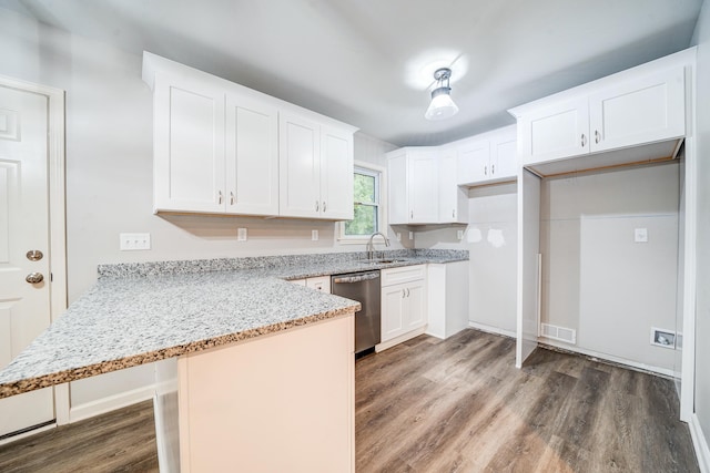 kitchen with dark hardwood / wood-style floors, light stone countertops, white cabinets, dishwasher, and kitchen peninsula