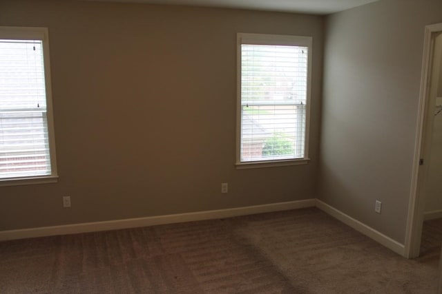 empty room featuring dark colored carpet