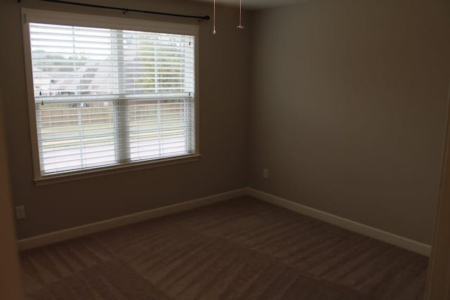 empty room featuring dark carpet