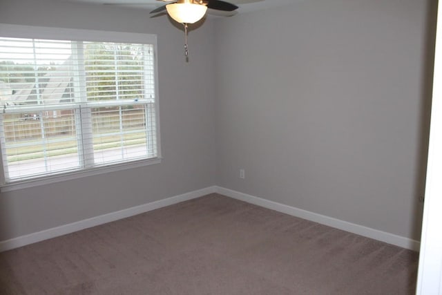 carpeted empty room featuring ceiling fan