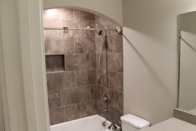 full bathroom featuring toilet, vanity, and tiled shower / bath