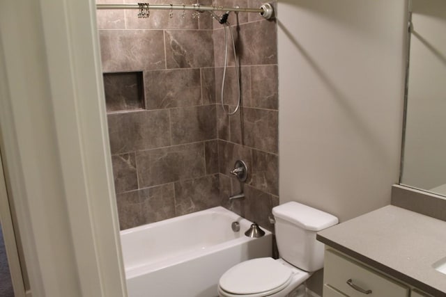 full bathroom with toilet, tiled shower / bath combo, and vanity