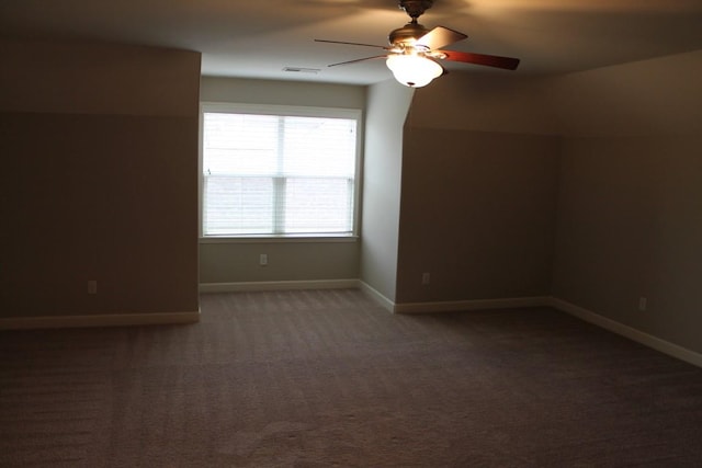 bonus room featuring dark colored carpet and ceiling fan