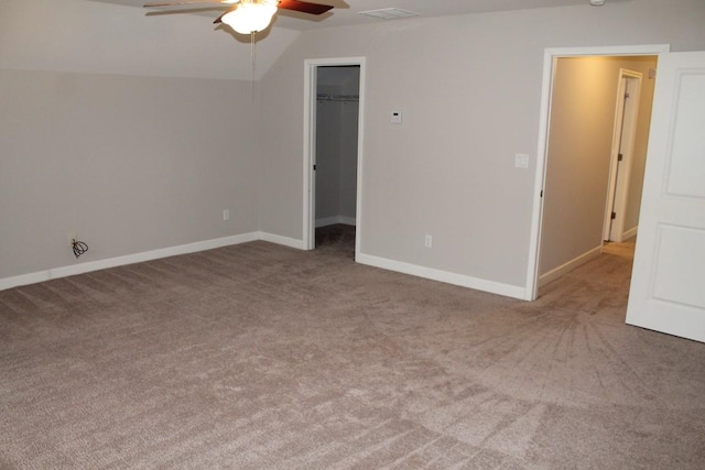 unfurnished room with ceiling fan, light colored carpet, and vaulted ceiling