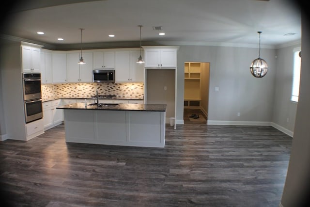 kitchen featuring an island with sink, white cabinetry, dark wood-type flooring, and appliances with stainless steel finishes