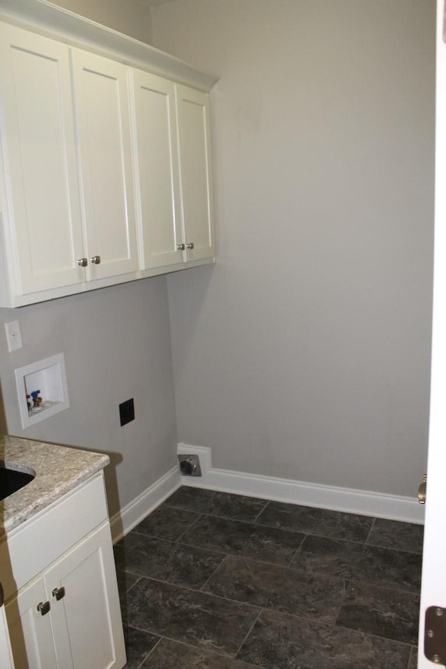 clothes washing area with cabinets and washer hookup