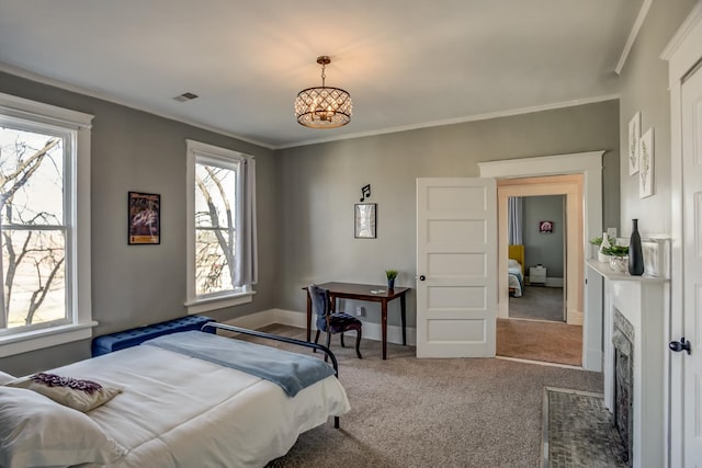 carpeted bedroom featuring multiple windows and crown molding