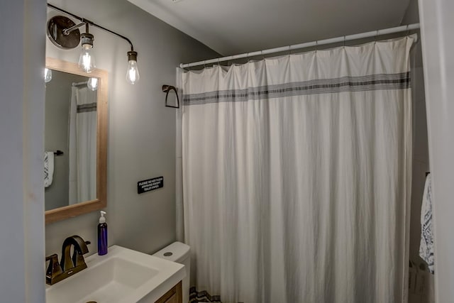 bathroom with vanity, curtained shower, and toilet