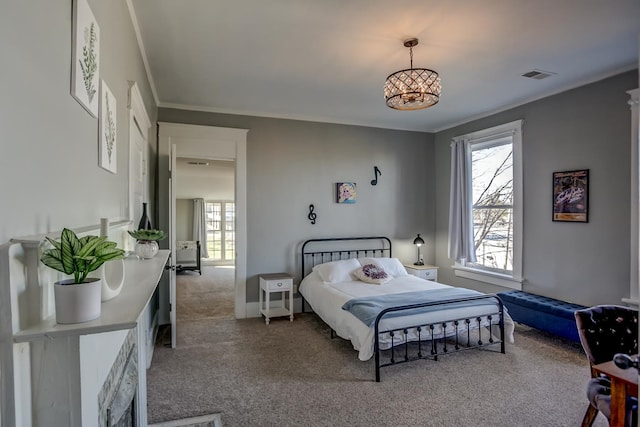 bedroom with ornamental molding and carpet floors