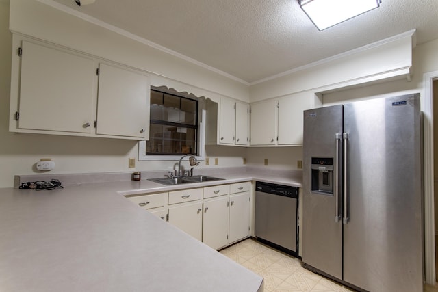 kitchen with stainless steel appliances, white cabinetry, a textured ceiling, and crown molding