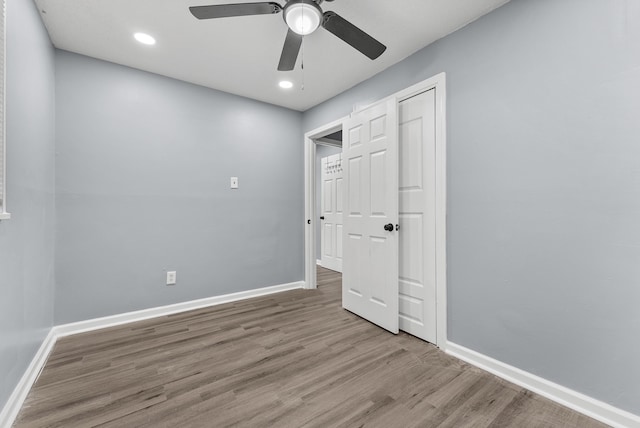 unfurnished bedroom featuring a closet, ceiling fan, and light hardwood / wood-style flooring