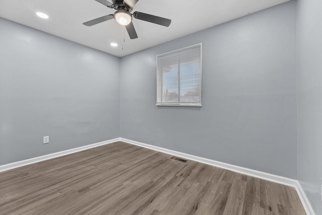 spare room with hardwood / wood-style floors and ceiling fan