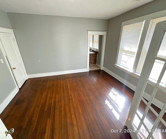 unfurnished bedroom with dark hardwood / wood-style flooring