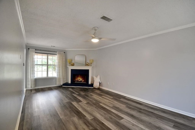 unfurnished living room with ceiling fan, a textured ceiling, dark hardwood / wood-style flooring, and ornamental molding