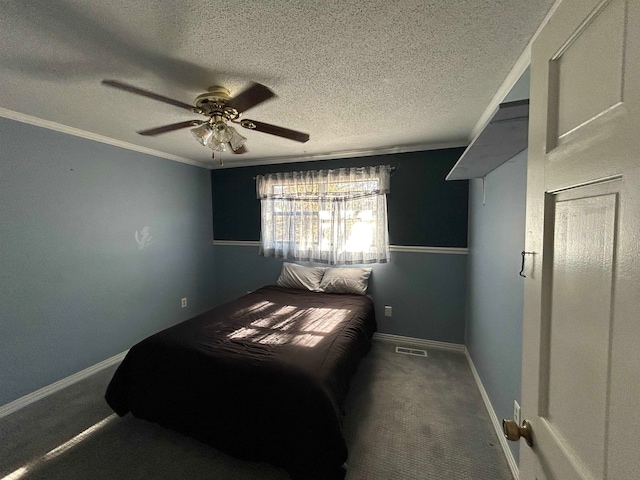 carpeted bedroom with ceiling fan, a textured ceiling, and ornamental molding