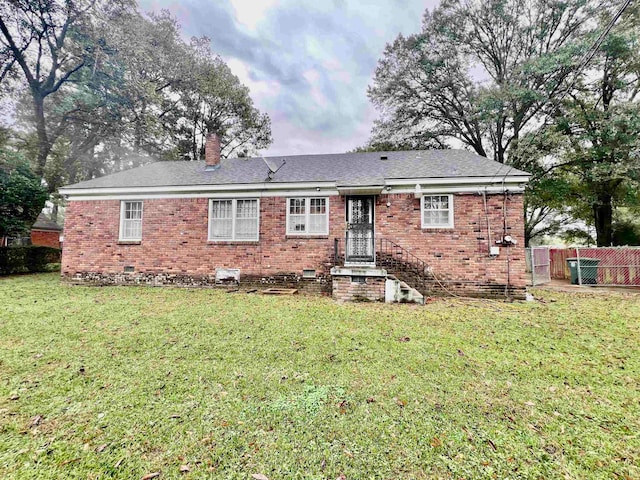 back of house with a lawn