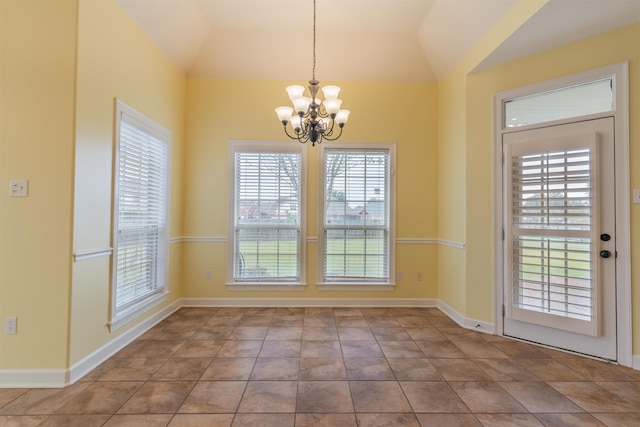 unfurnished dining area with tile patterned flooring, an inviting chandelier, and vaulted ceiling