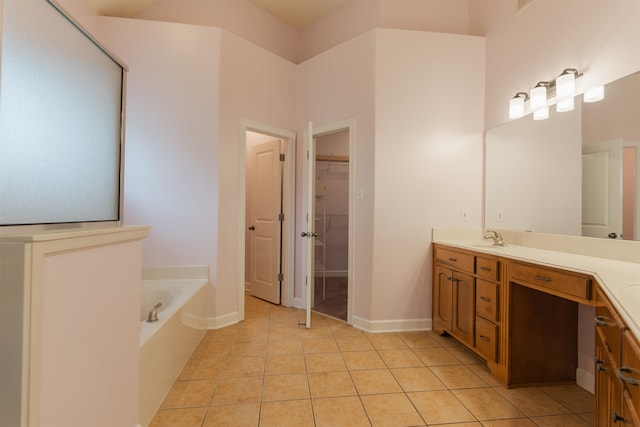 bathroom with a bath, tile patterned floors, and vanity