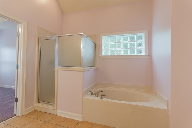 bathroom featuring tile patterned flooring and shower with separate bathtub