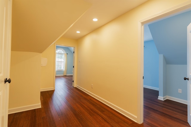 bonus room with vaulted ceiling and dark hardwood / wood-style flooring