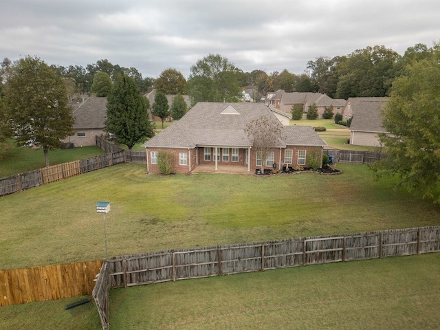 back of house with a lawn and a patio area