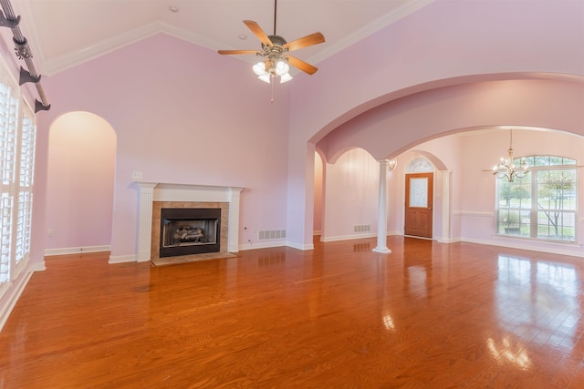 unfurnished living room featuring hardwood / wood-style floors, a wealth of natural light, and ornamental molding