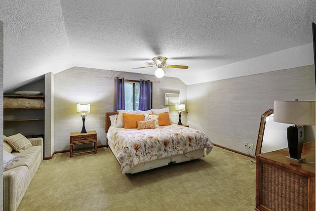 carpeted bedroom featuring a wall mounted air conditioner, a textured ceiling, vaulted ceiling, and ceiling fan