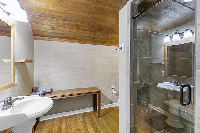 bathroom featuring sink, hardwood / wood-style floors, wooden ceiling, and a shower with shower door